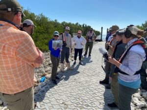 Project partners discuss project benefits and celebrate the NAWCA announcement at East Cape Canal. Photo by Jeff Beal, DU