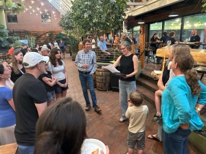 Woman at an outdoor restaurant during a going away party surrounded by people.
